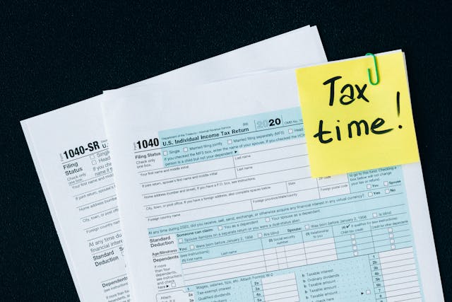 Documents paper clipped together with a note that says "Tax time!